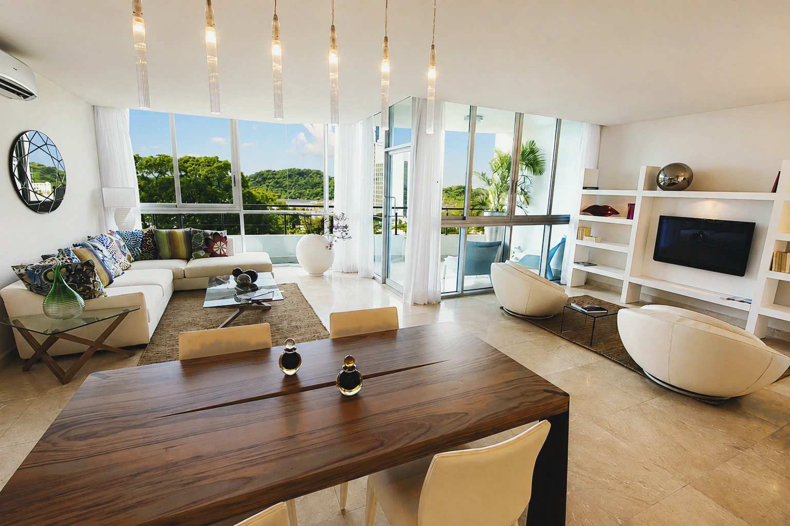 Floor-to-ceiling glass opens a Casa Bonita living room onto the treetops